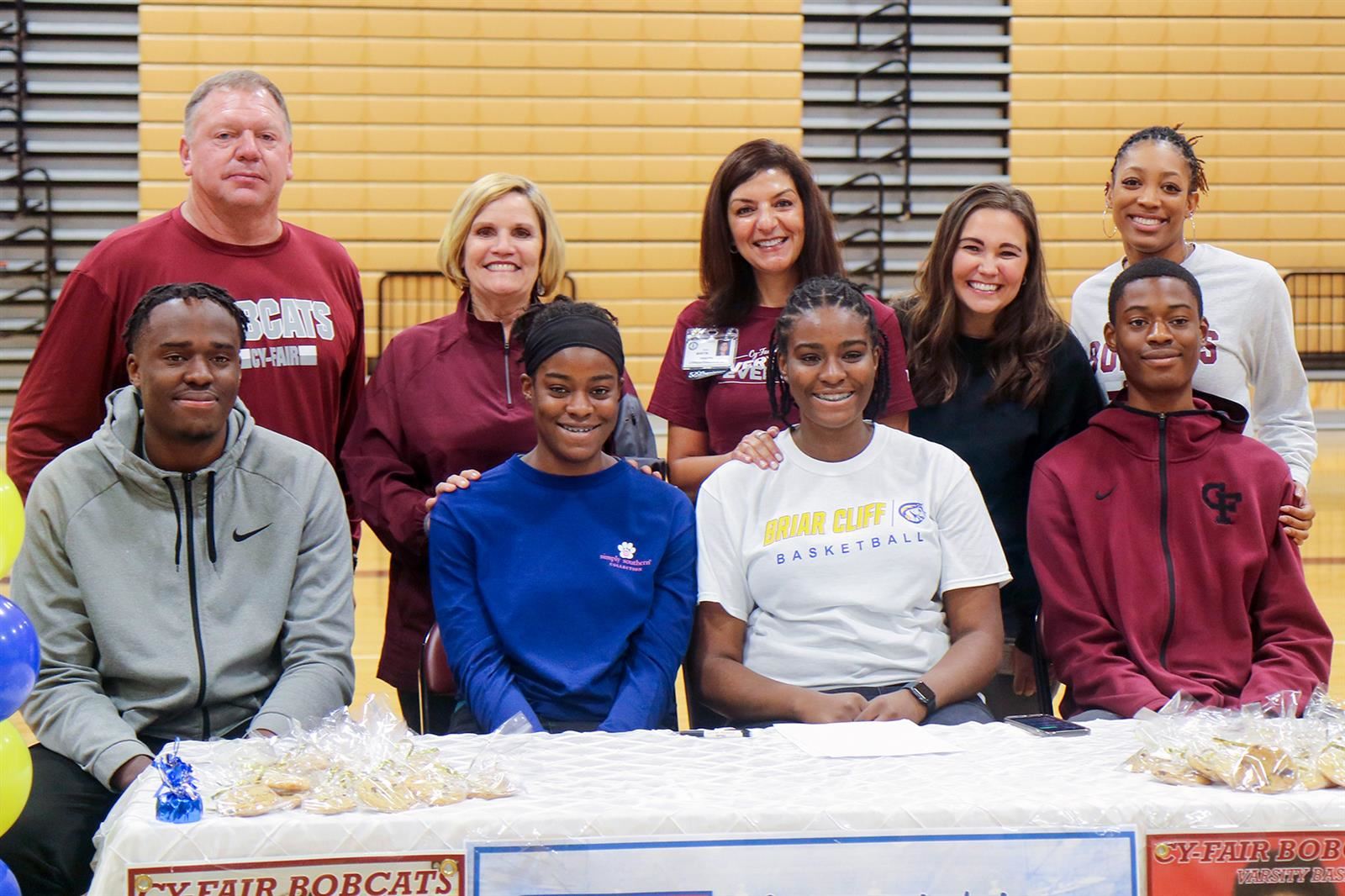 Cy-Fair High School senior Naomi Aigberadion, center second from right, signed a letter of intent to play basketball.